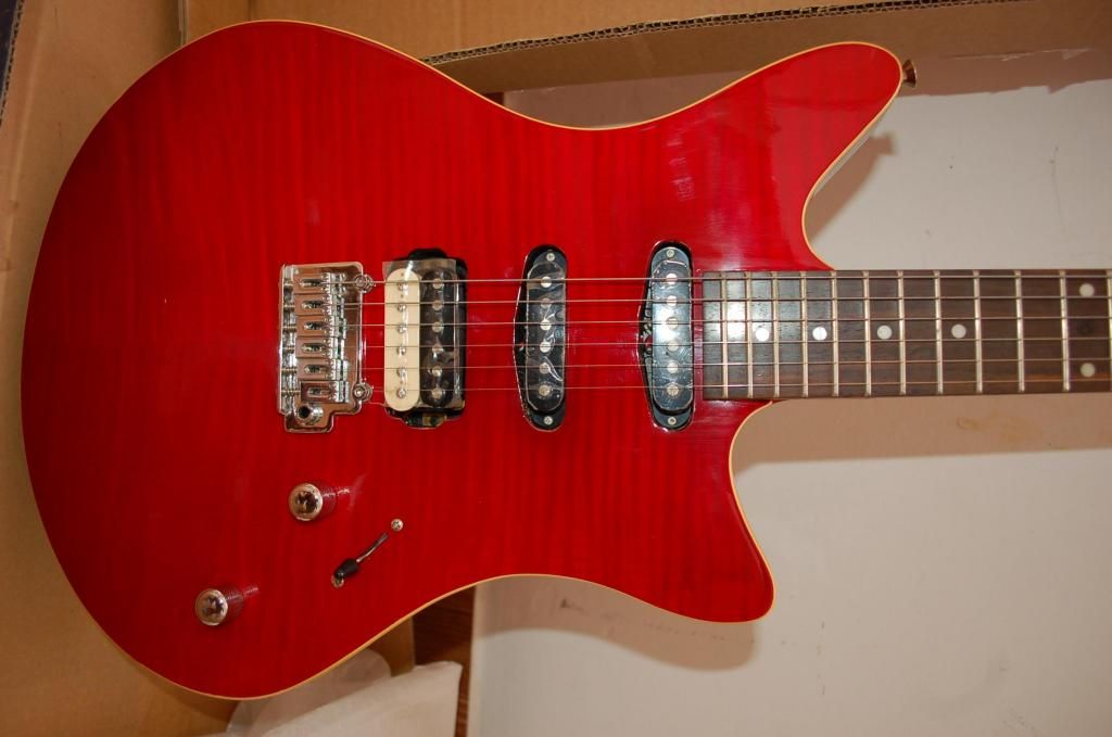 guitarra electrica nueva en caja rojo brillante marca canvas
